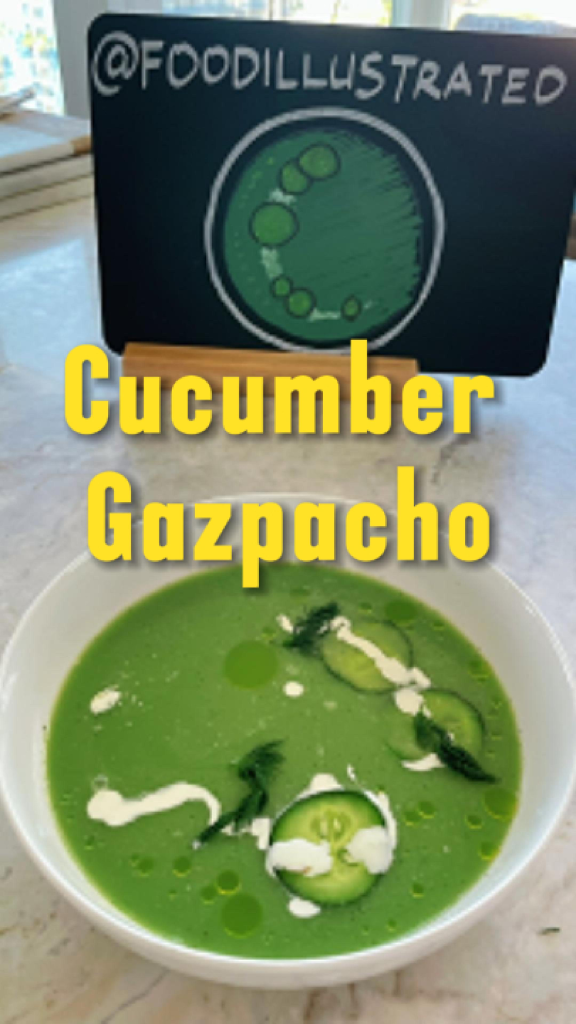 A vibrant green Cucumber Gazpacho served in a white bowl garnished with fresh dill, diced cucumber, and a drizzle of olive oil on a rustic wooden table.