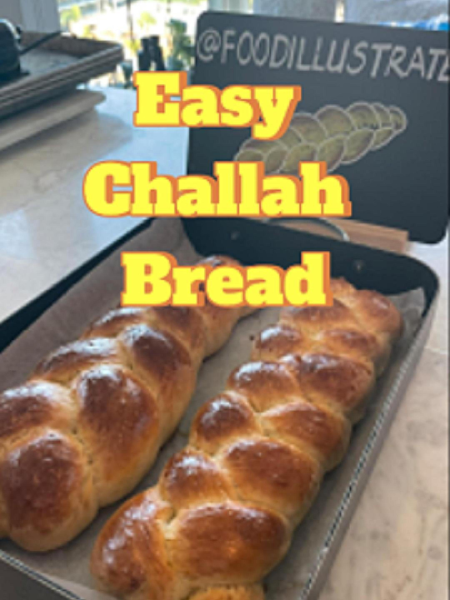 Golden brown Easy Challah Bread with a perfect 3-strand braid, sprinkled with sesame seeds and resting on a wire cooling rack.