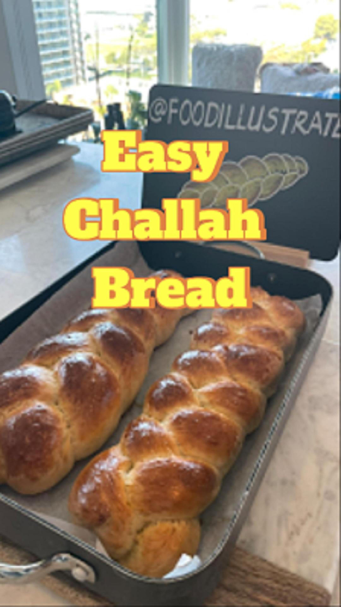 Golden brown Easy Challah Bread with a perfect 3-strand braid, sprinkled with sesame seeds and resting on a wire cooling rack.
