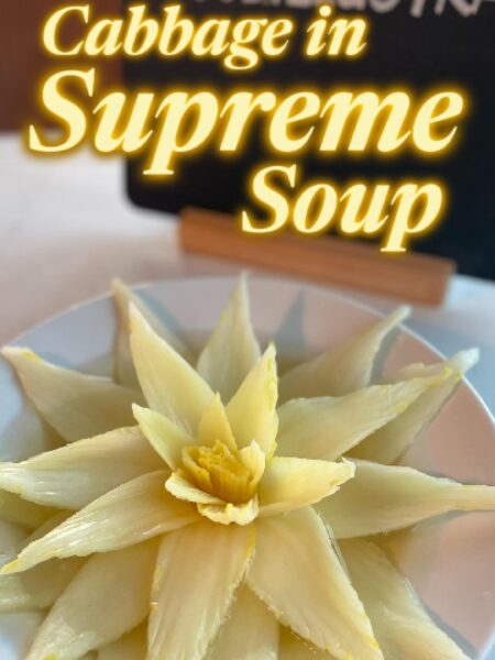 Chinese Consommé Kaishui Baicai served in a white bowl with a delicate cabbage heart submerged in crystal-clear amber-gold broth.