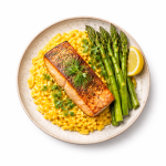 Pan seared salmon with crispy skin and fresh herbs on a white plate for a healthy breakfast or brunch