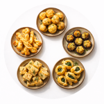 Five homemade snack items including cookies, baklava, brownies, energy bites, and fruit on a wooden platter