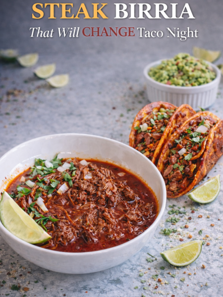 A stack of crispy quesabirria tacos with a bowl of rich, deep-red consommé for dipping, garnished with fresh cilantro and lime wedges.