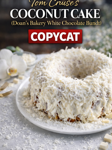 Tom Cruise's famous coconut cake copycat—a golden Bundt cake with white chocolate, toasted coconut, and caramel bits, topped with fluffy coconut cream cheese frosting and shredded coconut.