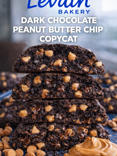 Stack of giant homemade Levain Bakery copycat cookies with dark chocolate and peanut butter chips on a rustic wooden table