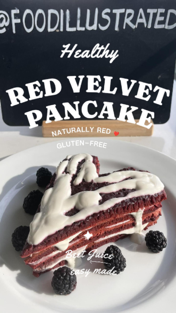 A tall stack of healthy red velvet pancakes cut into a perfect heart shape, topped with white cream cheese drizzle and fresh raspberries