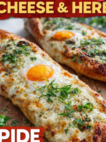 Golden brown Turkish Cheese and Herb Pide boat-shaped flatbread topped with a perfectly baked runny egg, fresh herbs, and sesame seeds on a wooden board.